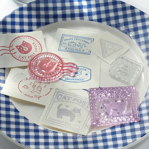 Decorative items with cat-themed stamps and seals on a blue and white checkered background