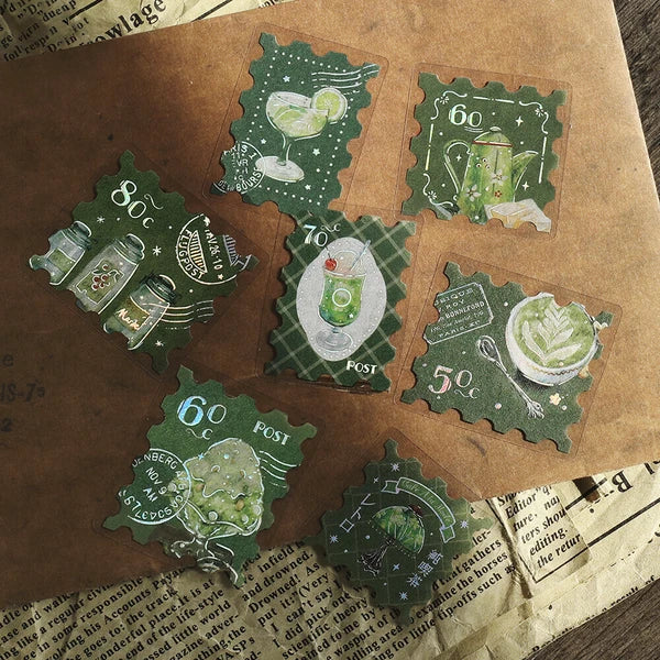 Set of green vintage-style postage stamps on a brown surface with text