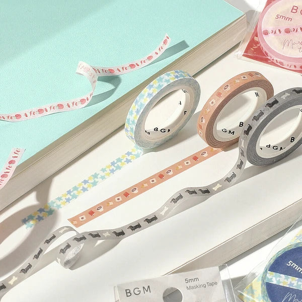 Set of colorful washi tape rolls on a light blue background