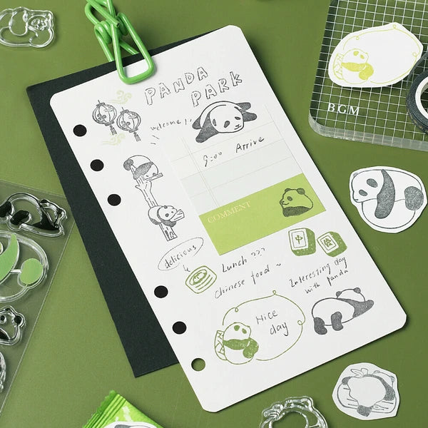 Panda-themed stationery set with a planner and stickers on a green background
