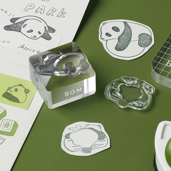 Clear rubber stamp with panda design on a green surface