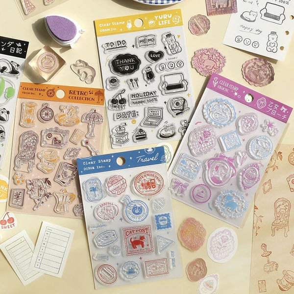 Collection of clear stamps with various designs on a beige surface