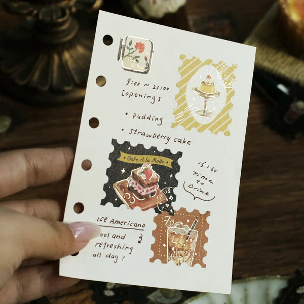 Hand holding a decorative menu card with illustrations of food and drinks.
