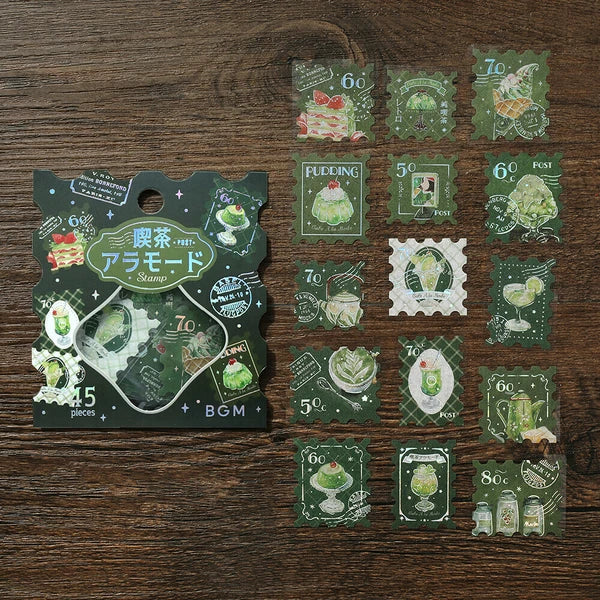 Set of green-themed decorative stamps on a wooden surface