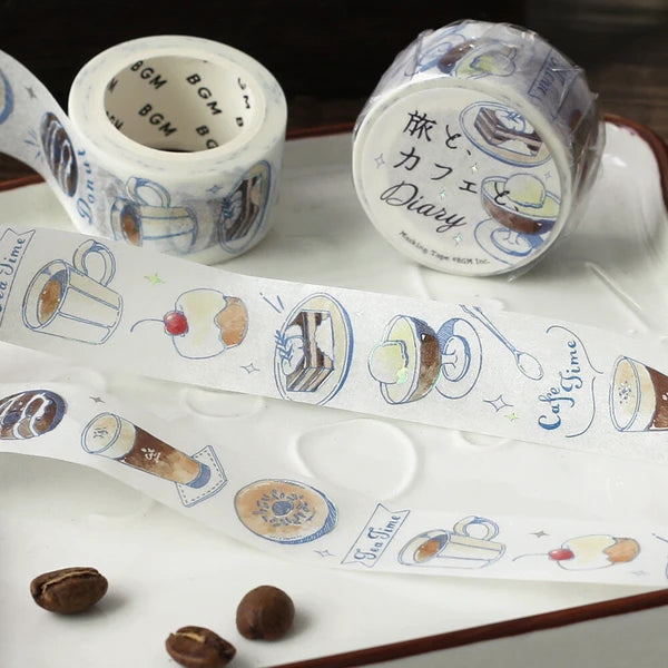 Decorative tape with coffee-themed designs on a white surface with coffee beans.