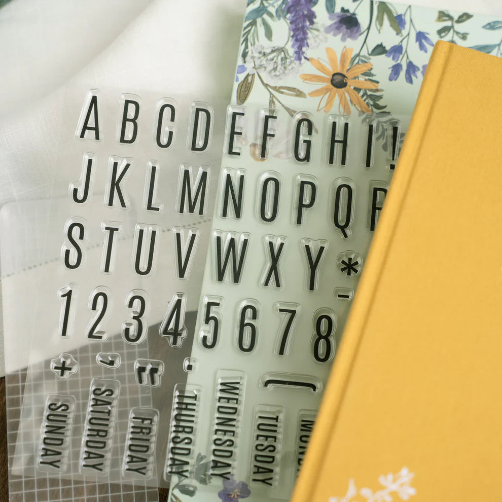 Alphabet and number stamps with a floral background. June Quarterly Box Beekeeper’s Garden from Archer & Olive.